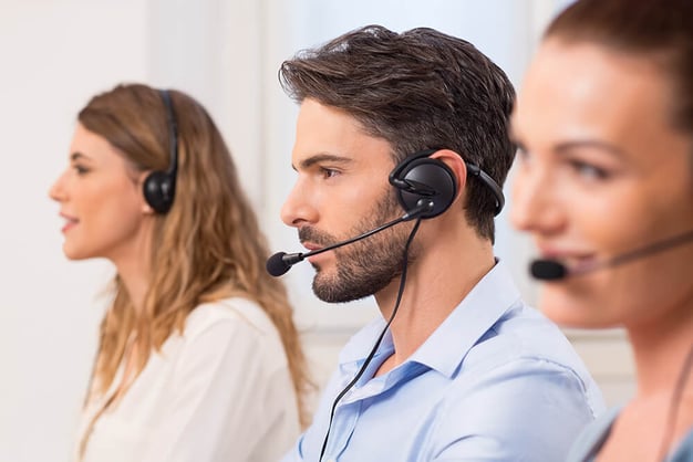 People working at a support desk 